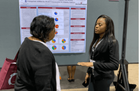 Teacher talking with student during presentation